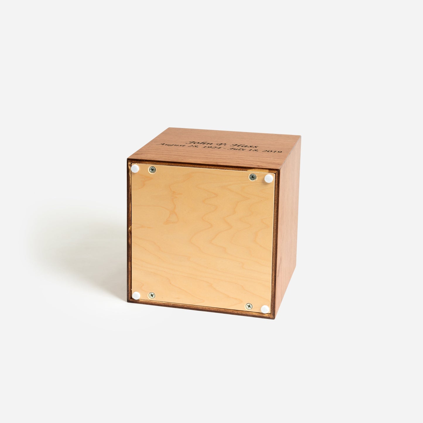 Underside of cherry cremation urn showing secure screw-fastened panel