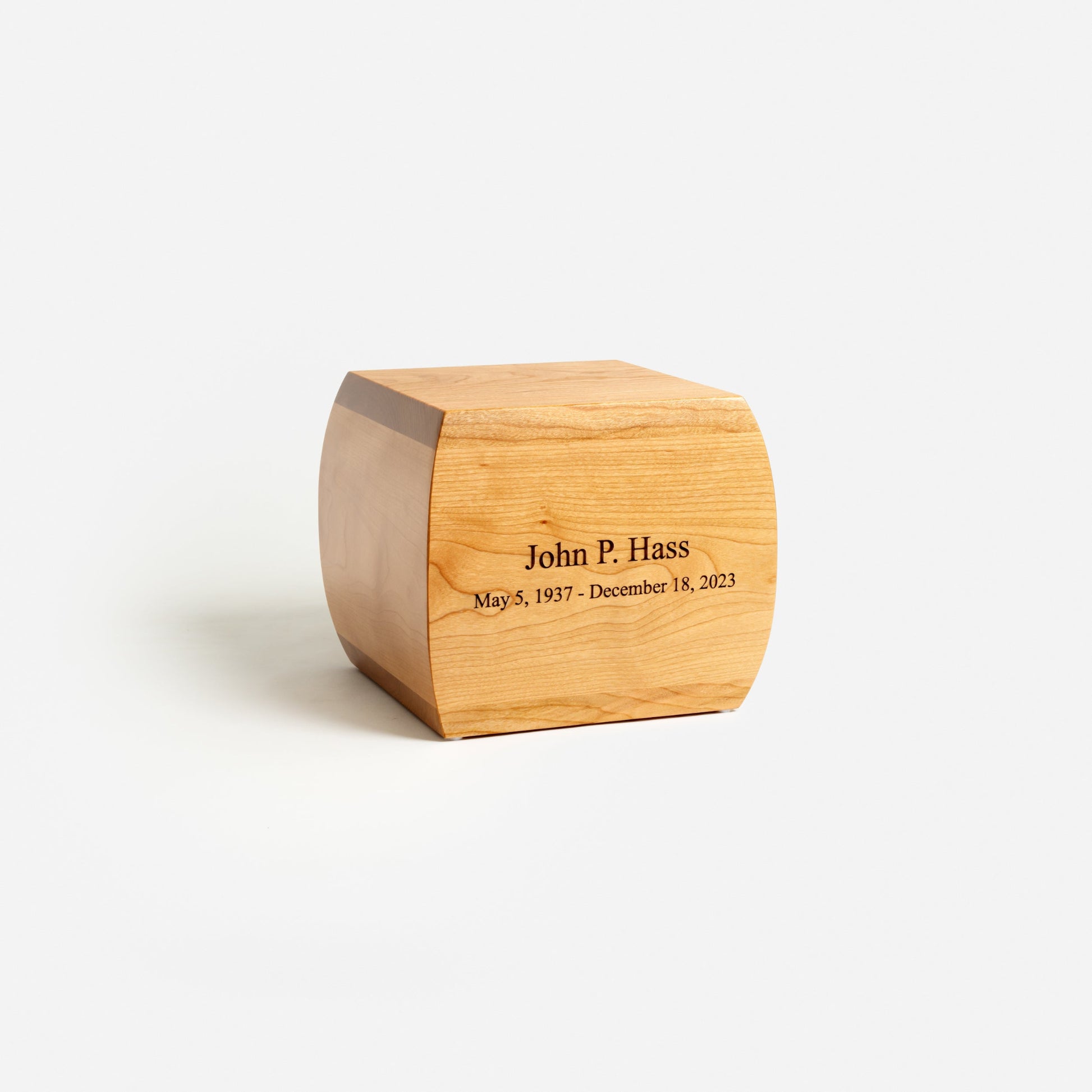 Angled view of curved cherry wood urn – soft contours and refined craftsmanship
