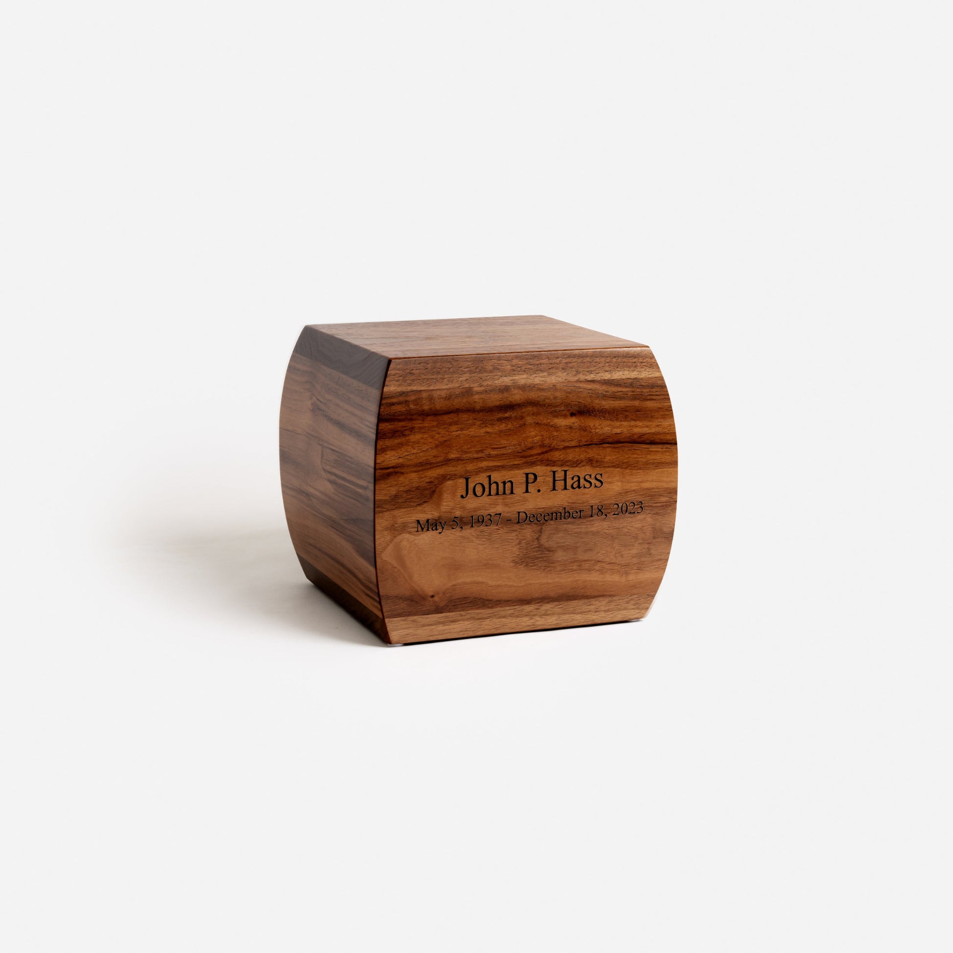 Angled view of curved walnut urn – soft curves and elegant craftsmanship