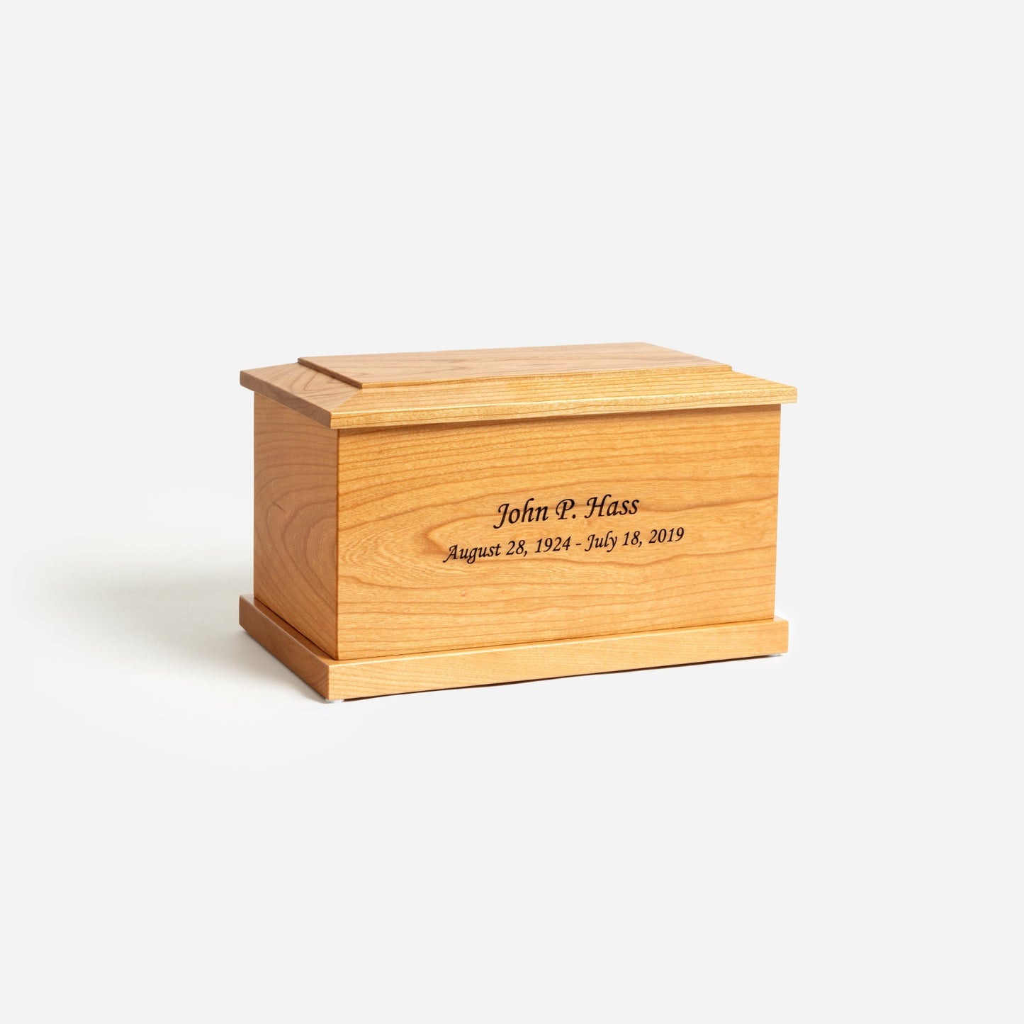 Angled front image of solid cherry cremation urn showing wood grain and handcrafted detail