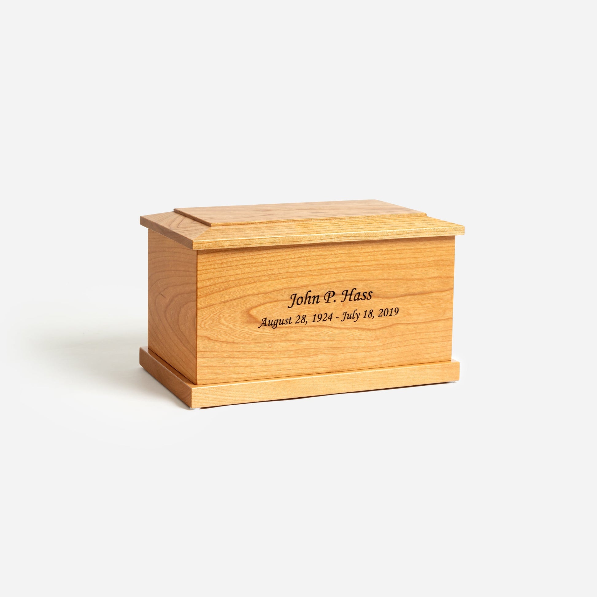 Angled front image of solid cherry cremation urn showing wood grain and handcrafted detail