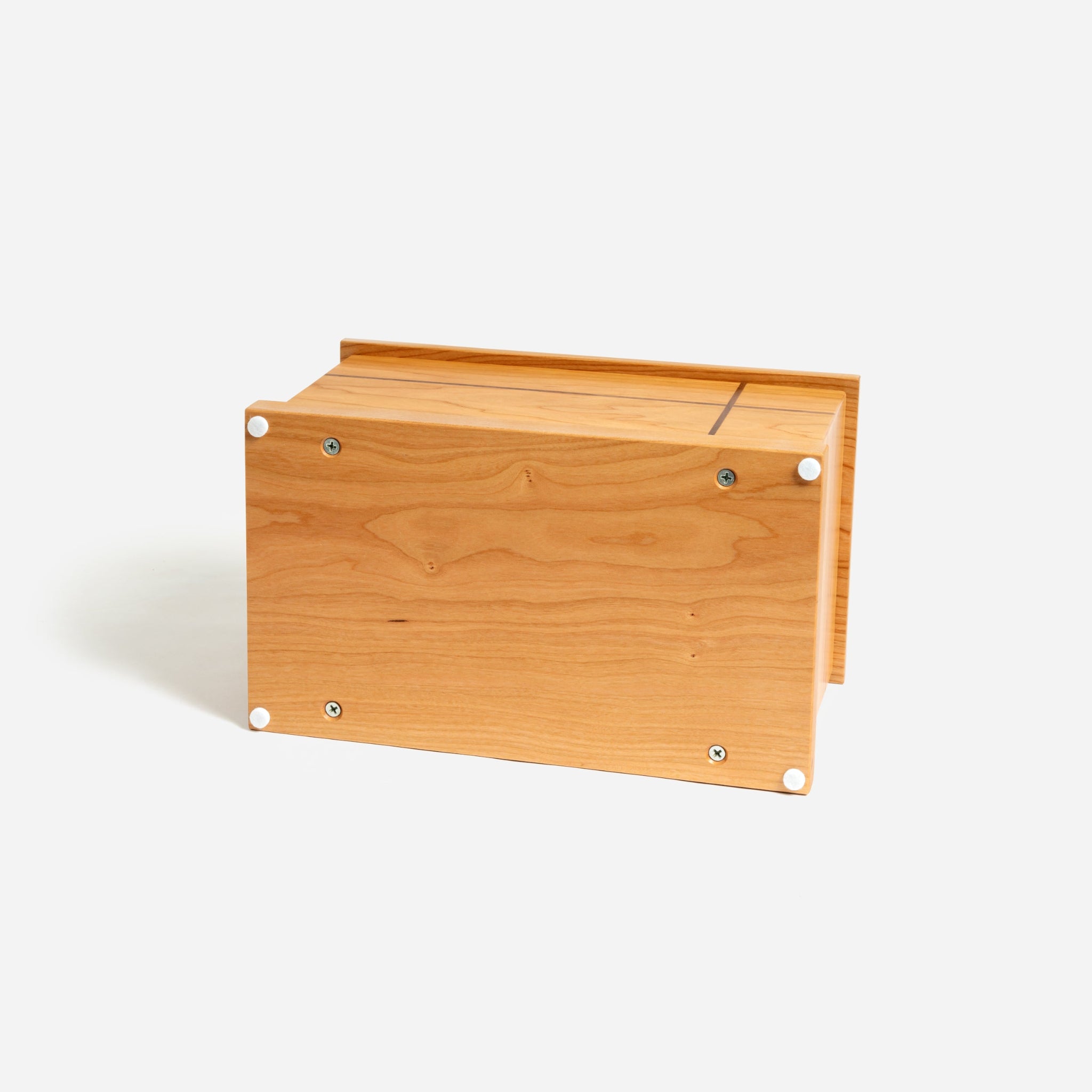 Bottom of cherry wood memorial urn showing screw-on panel for secure ash placement