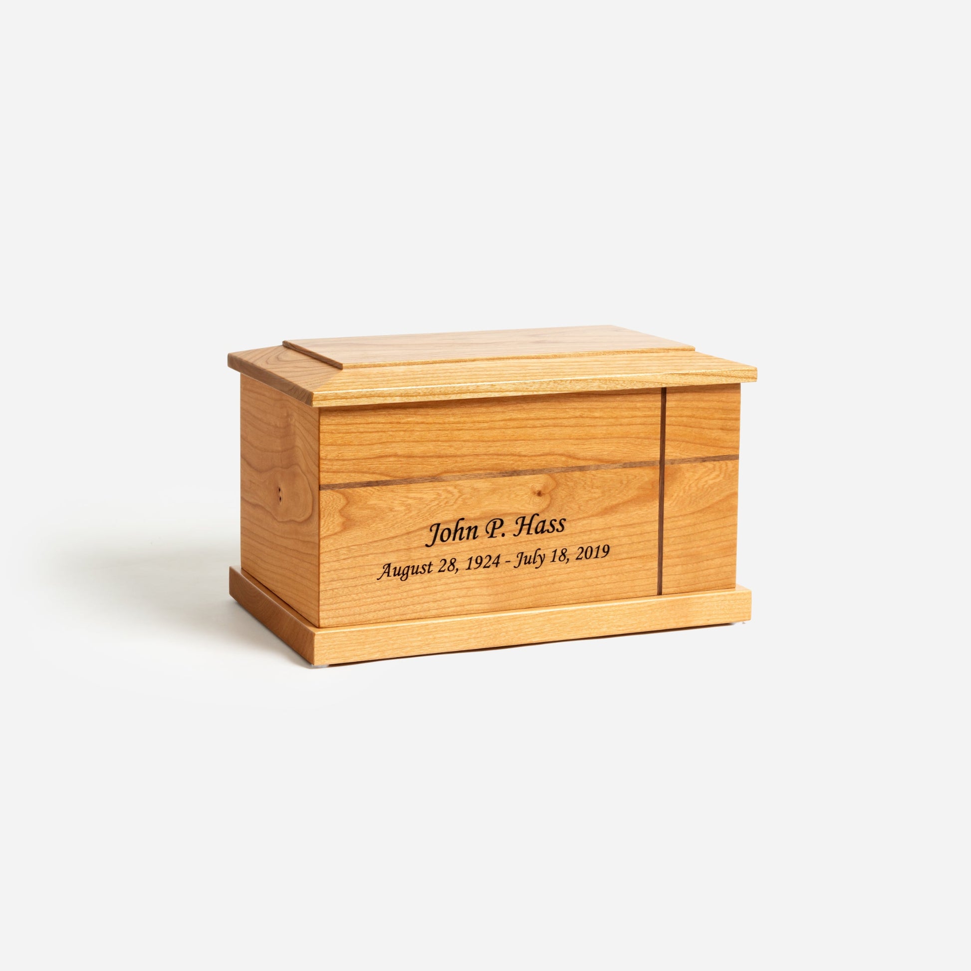 Angled front image of traditional cherry urn showing cross design and warm lacquer finish