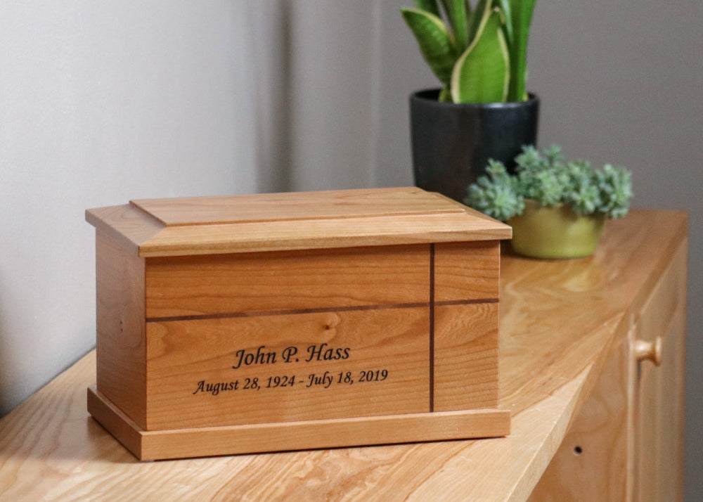 Traditional cherry wood urn with cross displayed in home setting – elegant and dignified tribute