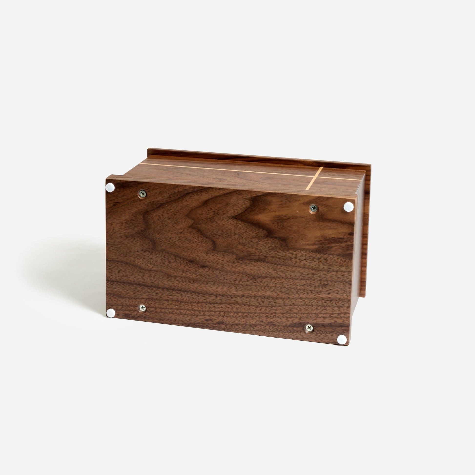 Bottom of walnut cremation urn showing secure panel with screw closure