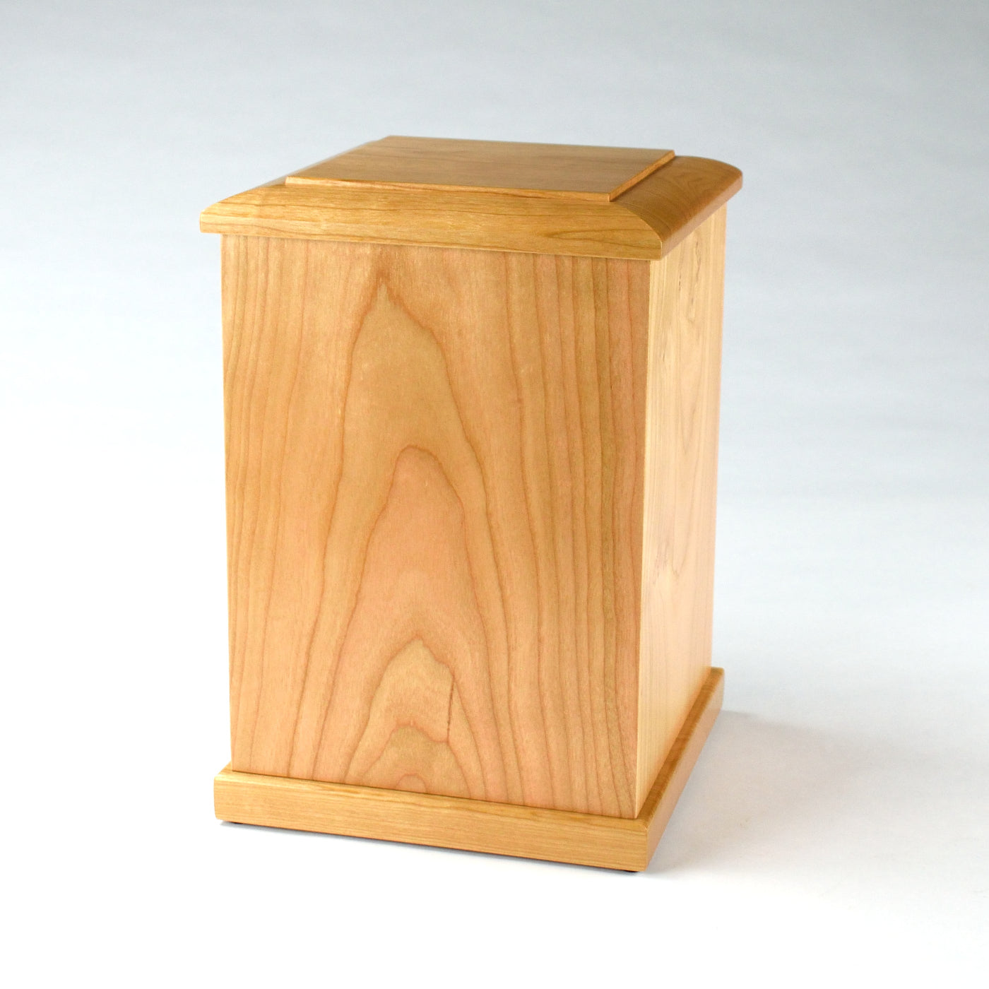 Side profile of upright cherry memorial urn – solid wood design with custom engraving option