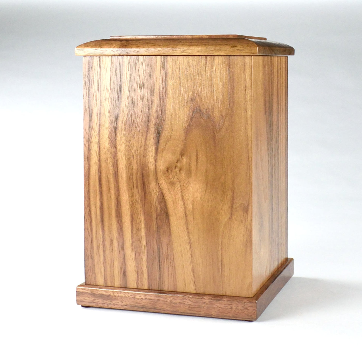 Angled front image of tall walnut urn showing natural wood grain and custom engraving area