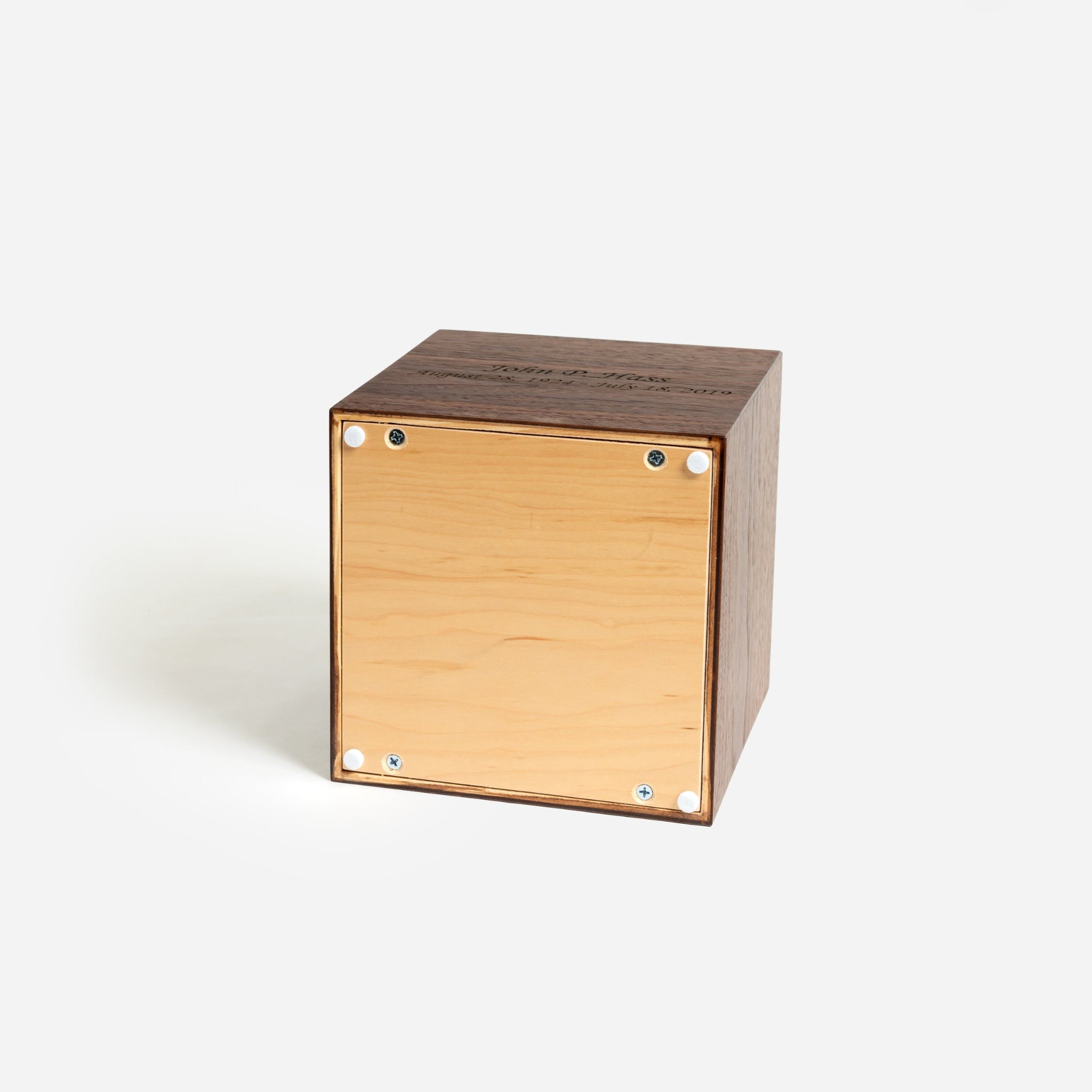 Bottom of bronze-stained walnut urn with screw-fastened panel for secure closure