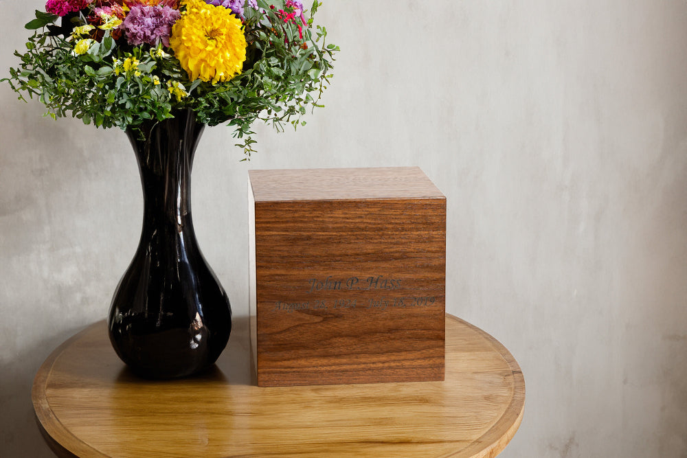Walnut cremation urn with bronze finish displayed in home setting – handcrafted memorial for loved one
